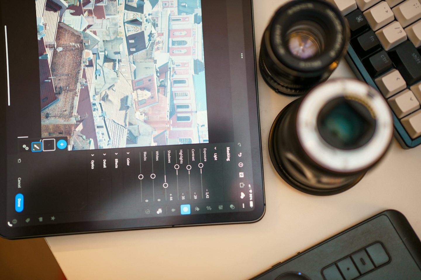 Digital editing tools and lenses arranged around a tablet.